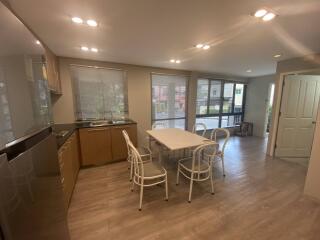 Dining area with table and chairs next to a kitchen