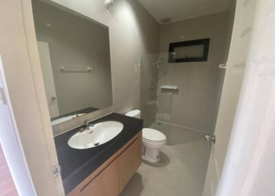 Modern bathroom with vanity, toilet, and shower