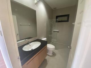 Modern bathroom with vanity, toilet, and shower