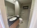 Modern bathroom with vanity, toilet, and shower