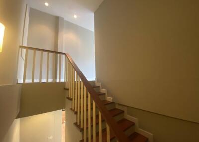 Modern interior staircase with wooden steps and white railings