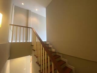 Modern interior staircase with wooden steps and white railings