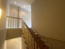 Modern interior staircase with wooden steps and white railings