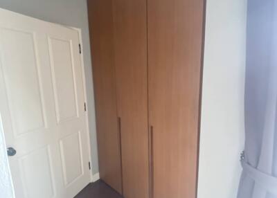 Bedroom with wooden wardrobe and white door