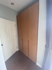 Bedroom with wooden wardrobe and white door