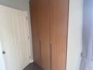 Bedroom with wooden wardrobe and white door