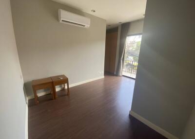 Empty modern living area with wooden floor and large window