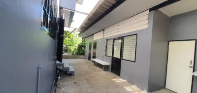 Outdoor building area with grey walls and glass windows