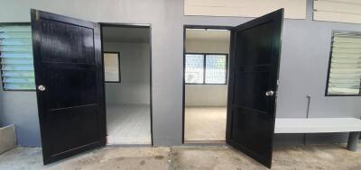 Front view of rooms with black doors