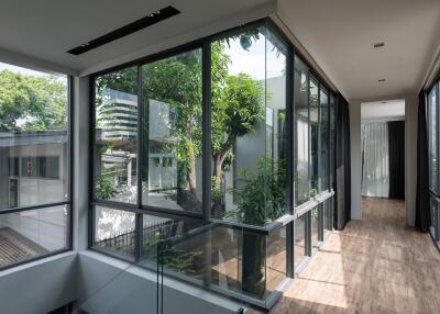 Bright hallway with large glass windows and wooden floors