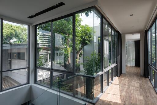 Bright hallway with large glass windows and wooden floors