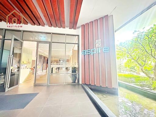 Entrance of Aspire building with signage and glass doors