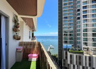 Cozy balcony with view of the ocean and neighboring buildings