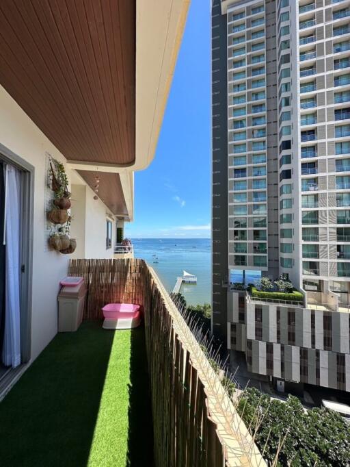 Cozy balcony with view of the ocean and neighboring buildings