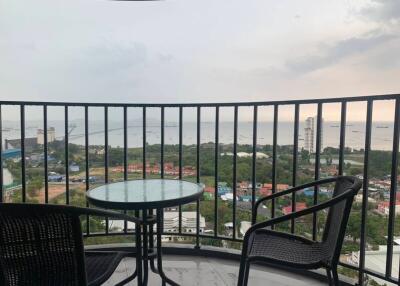 Balcony with chairs and a table overlooking a scenic view