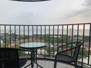 Balcony with chairs and a table overlooking a scenic view