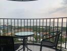 Balcony with chairs and a table overlooking a scenic view