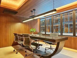 Modern office space with wooden paneling and large window.