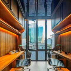 Modern home office with large window and built-in wooden desks