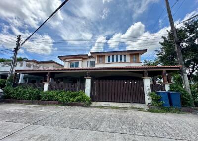 Front view of a two-story house with a gated entrance