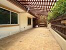 Covered outdoor patio with wooden flooring and pergola shade