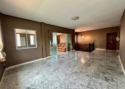 spacious living room with marble floor and staircase