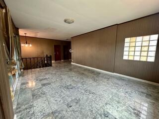 Spacious empty living room with marble flooring and large windows