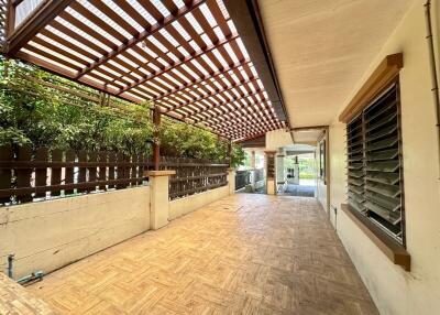 Covered outdoor terrace with wooden flooring