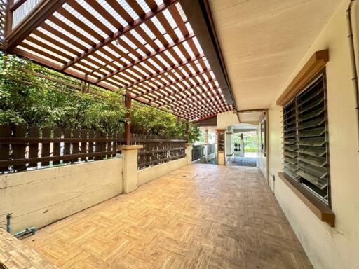 Covered outdoor terrace with wooden flooring