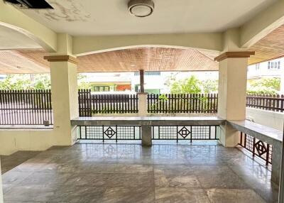 Spacious covered outdoor area with tiled flooring and ceiling light