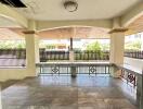 Spacious covered outdoor area with tiled flooring and ceiling light