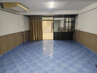 Spacious living room with tiled floor and large windows