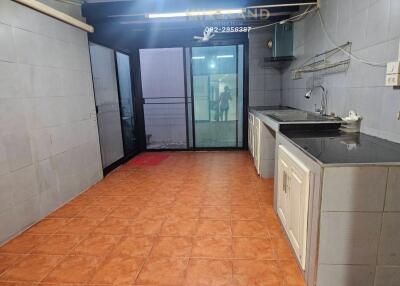 Modern kitchen with tiled floor and large windows for natural light