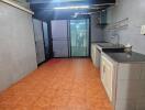 Modern kitchen with tiled floor and large windows for natural light