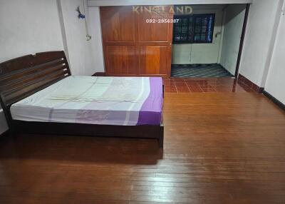 Bedroom with wooden floors and a large bed