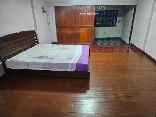 Bedroom with wooden floors and a large bed