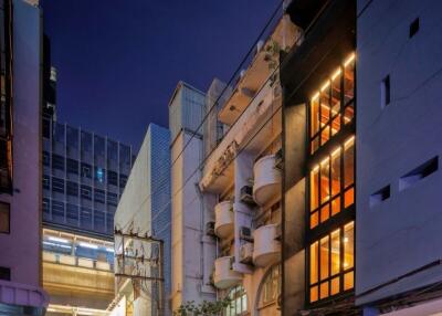 Exterior view of a modern building at night with illuminated windows