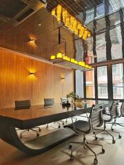 Modern conference room with glass table, sleek chairs, and contemporary lighting