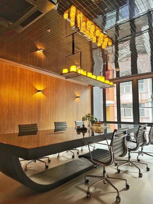 Modern conference room with glass table, sleek chairs, and contemporary lighting