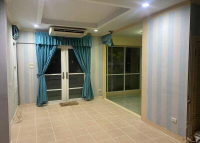 Living room with striped wallpaper, recessed lighting, air conditioning unit, and glass doors