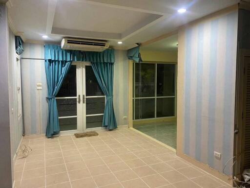 Living room with striped wallpaper, recessed lighting, air conditioning unit, and glass doors