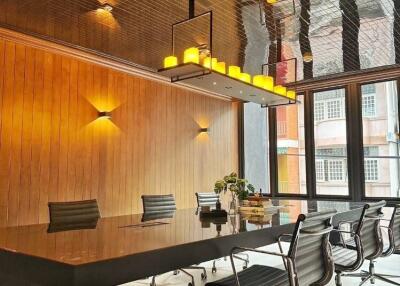 Modern conference room with wooden panel walls and decorative ceiling