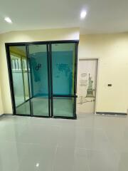 Empty room with glass door and decorative wall art