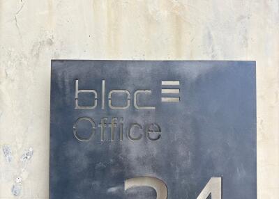 Building entrance with bloc office sign for suite 34