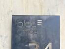 Building entrance with bloc office sign for suite 34