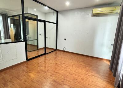 Spacious Bedroom with Wooden Floor and Large Glass Doors