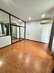 Spacious Bedroom with Wooden Floor and Large Glass Doors