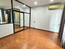 Spacious Bedroom with Wooden Floor and Large Glass Doors