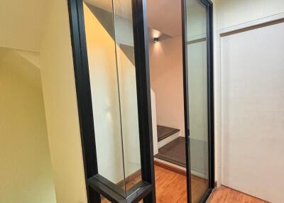 Modern stairwell with glass panels and wooden flooring