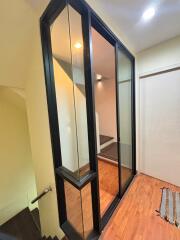 Modern stairwell with glass panels and wooden flooring